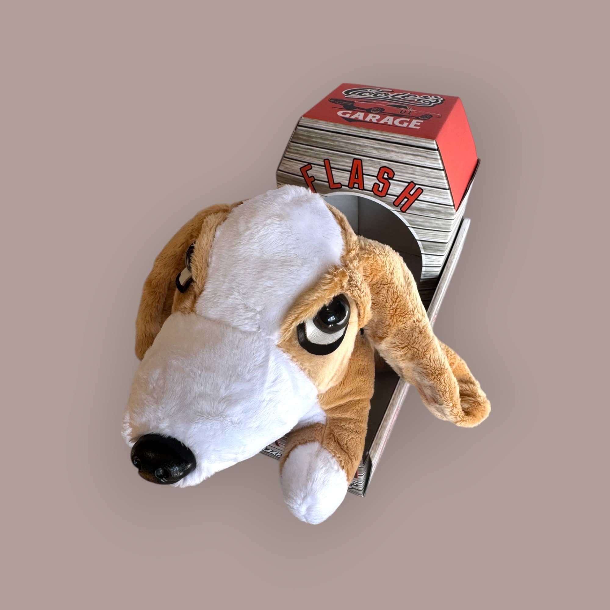 Flash the Bassett Hound plush toy — top view in Cooter's Garage branded crate