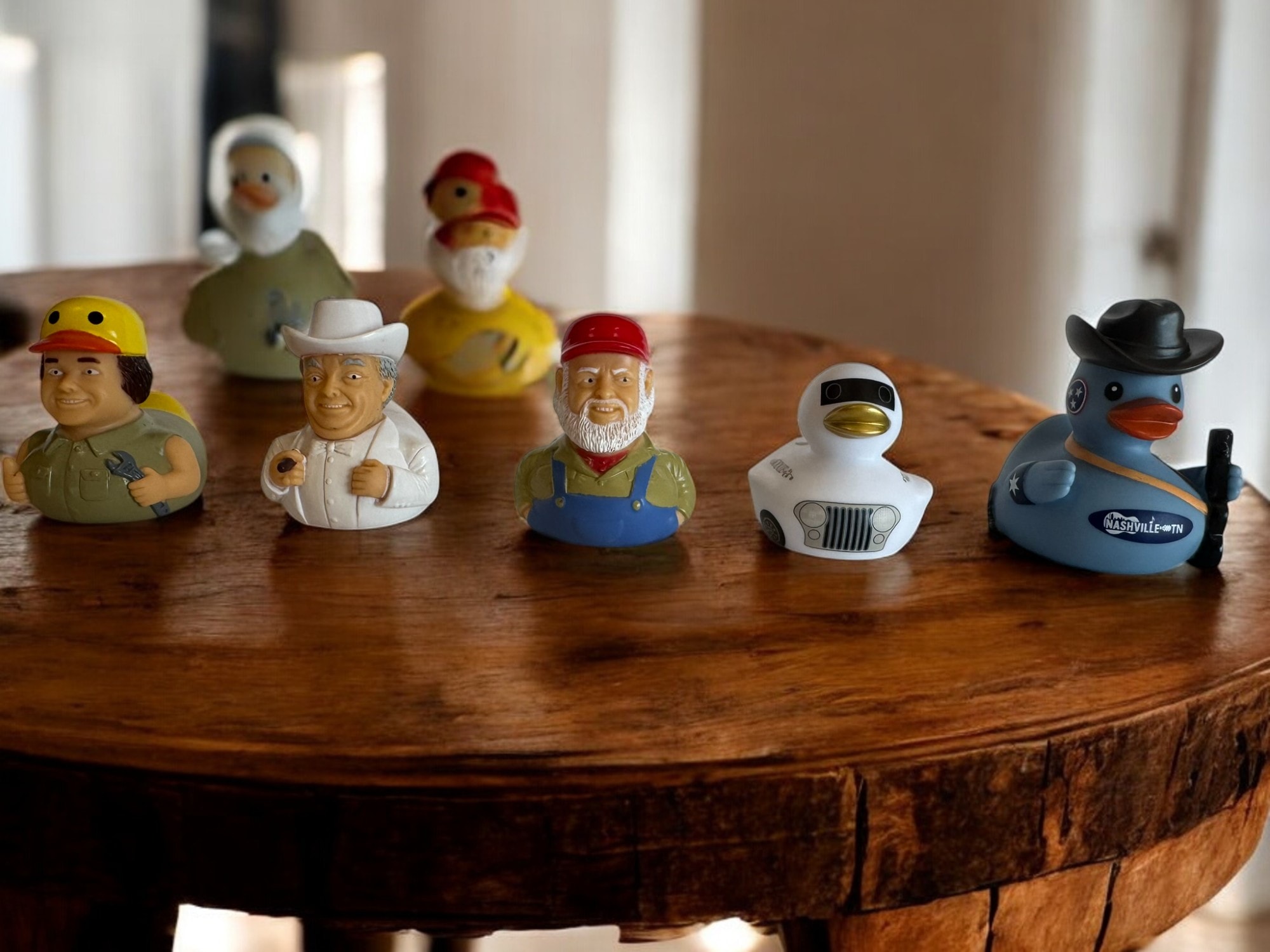 Full collection of Ducks of Hazzard rubber duck figurines displayed together on a wooden table