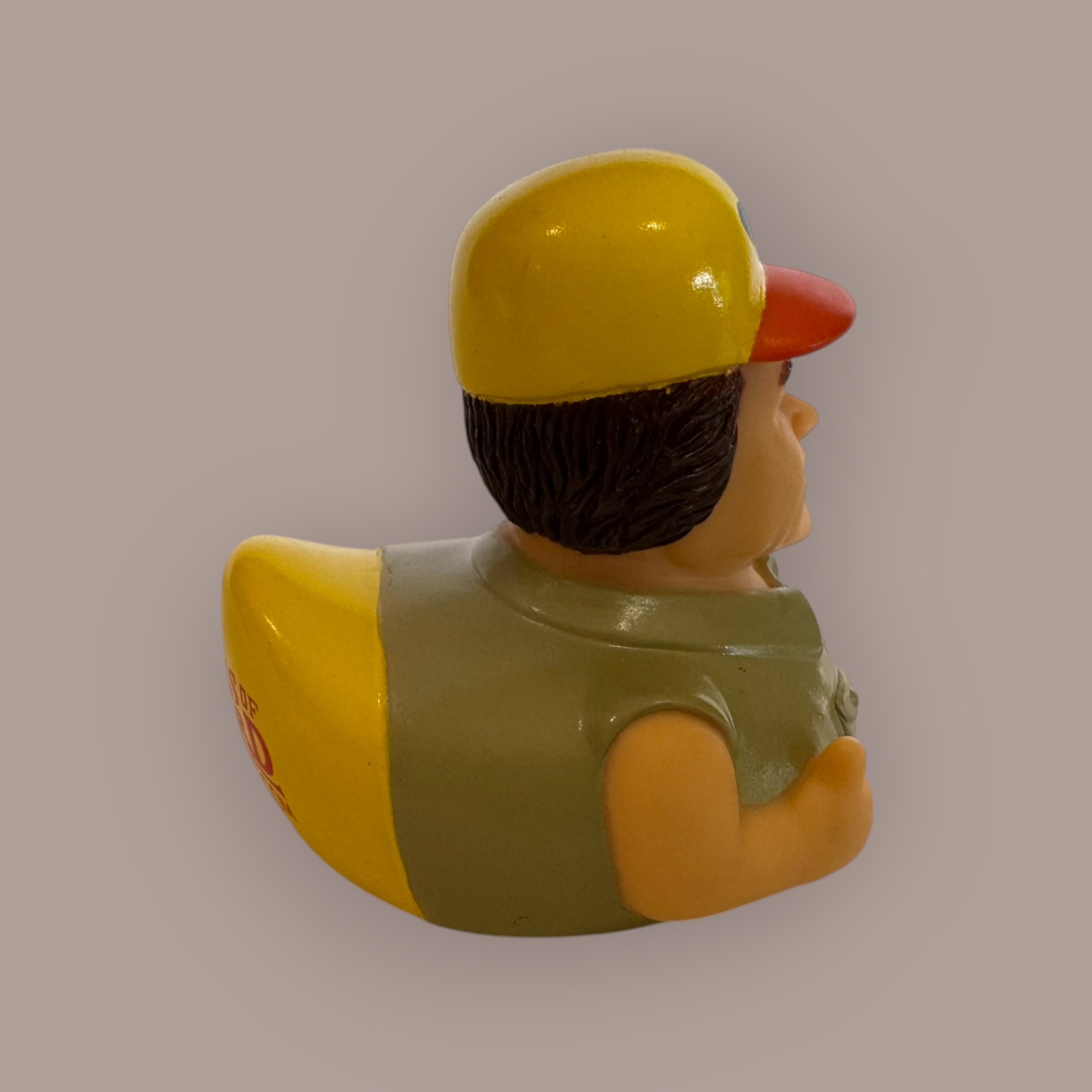 Mechanic duck figurine — back view, yellow hard hat