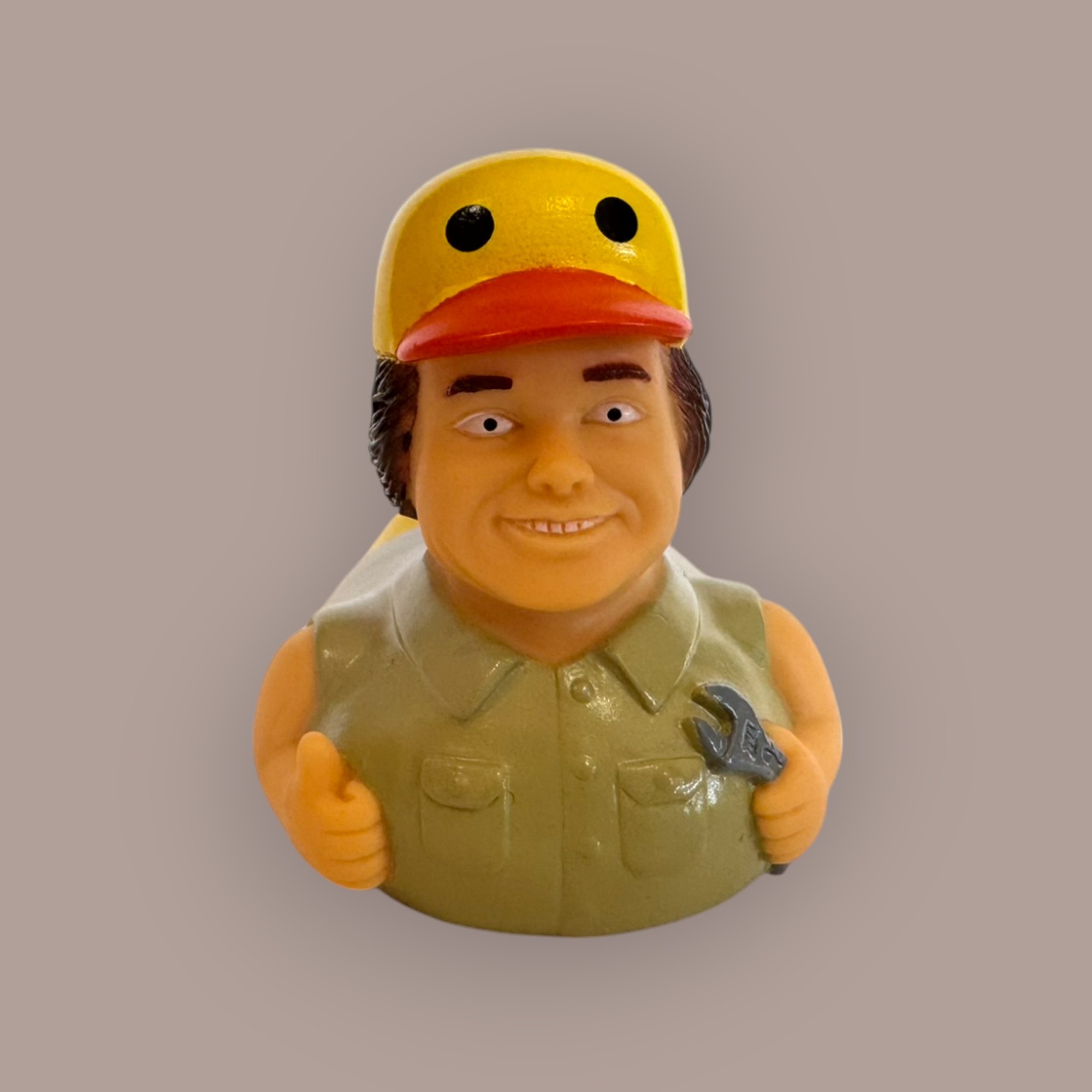 Mechanic duck figurine — front view, yellow hard hat, wrench