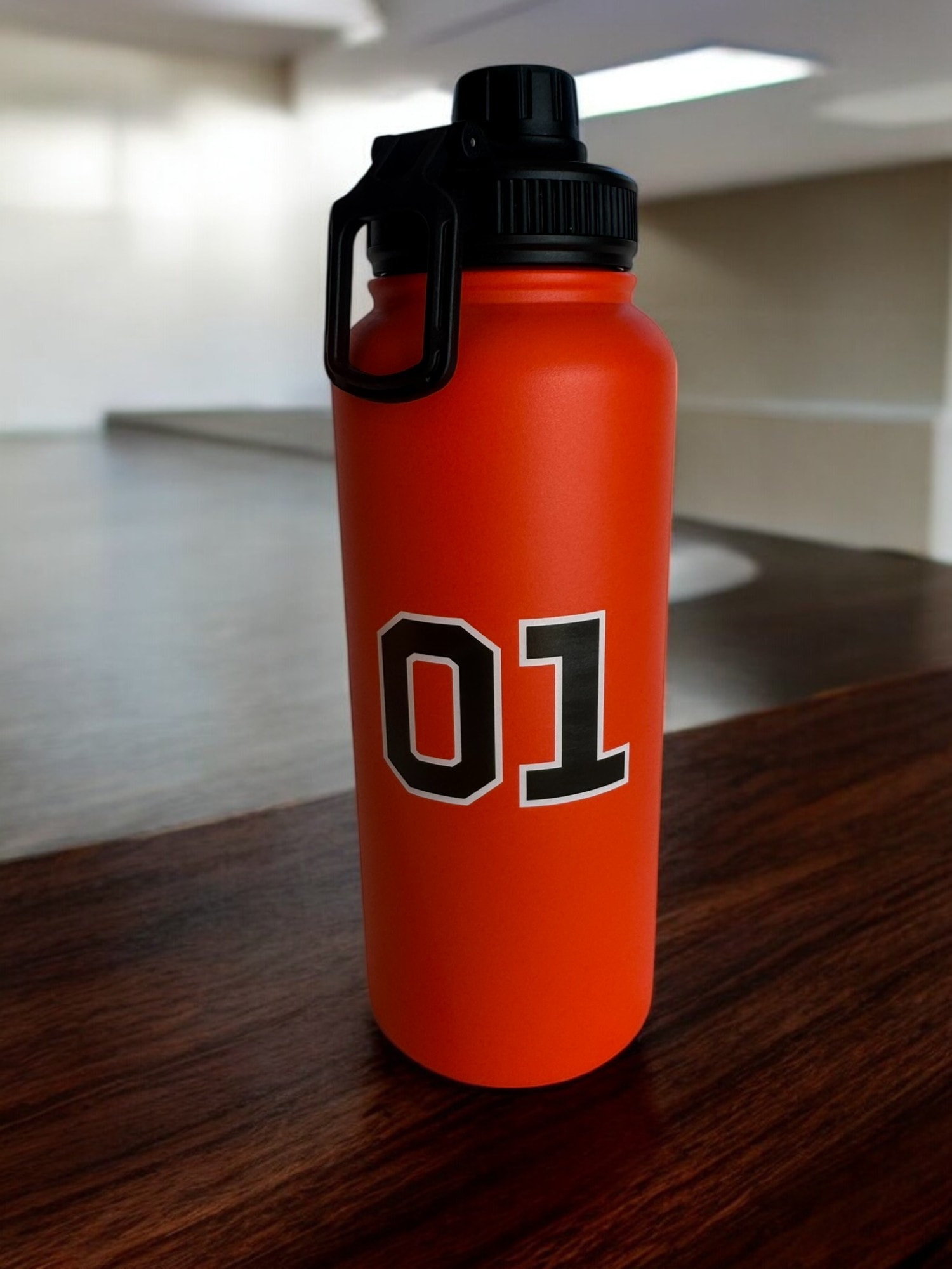 General Lee 01 water bottle — on table, lifestyle shot